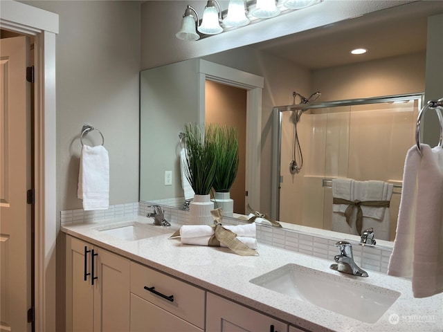 bathroom featuring decorative backsplash, vanity, and walk in shower