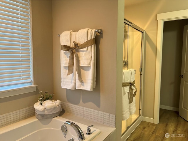 bathroom with plus walk in shower and hardwood / wood-style flooring