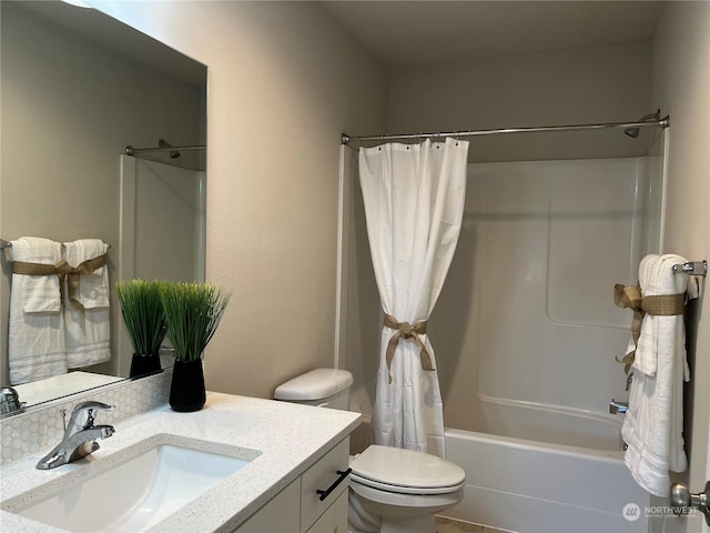 full bathroom featuring toilet, vanity, and shower / tub combo with curtain