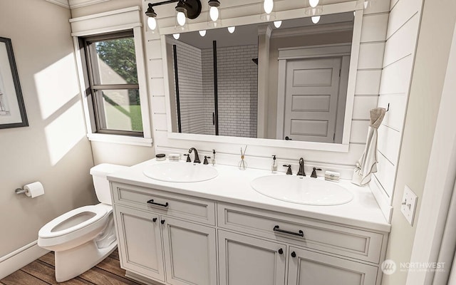 bathroom featuring ornamental molding, vanity, wood-type flooring, and toilet