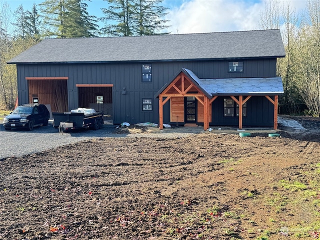 view of front facade featuring an outdoor structure and a garage