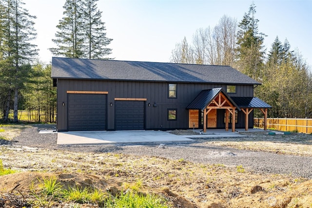 view of front of home with concrete driveway, fence, a porch, and a shingled roof
