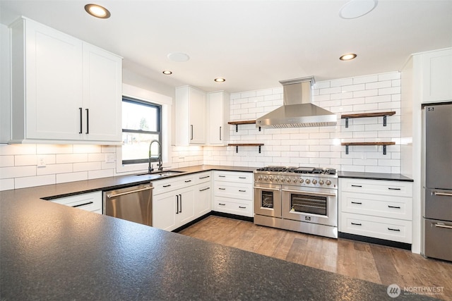 kitchen with open shelves, dark countertops, wall chimney range hood, and stainless steel appliances