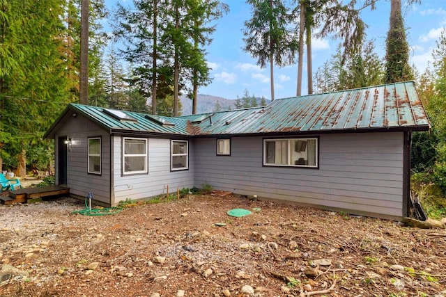 back of house featuring a deck