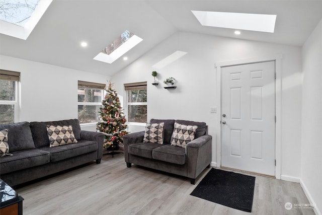 living room with light hardwood / wood-style floors and vaulted ceiling