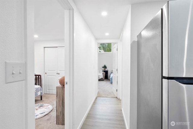 hallway with light hardwood / wood-style flooring