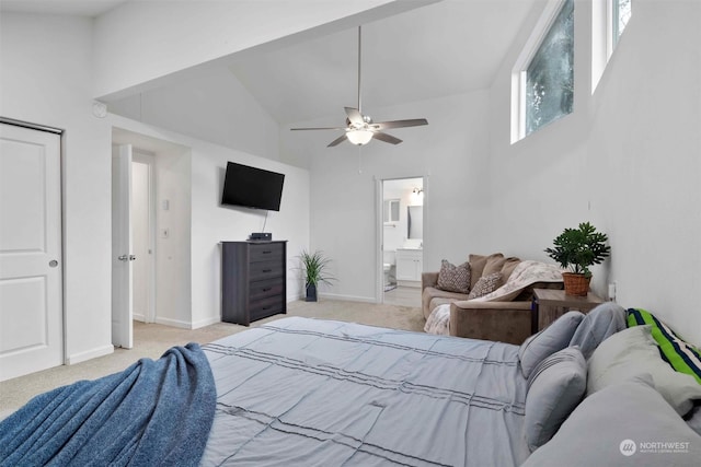 carpeted bedroom featuring ceiling fan, high vaulted ceiling, and ensuite bathroom