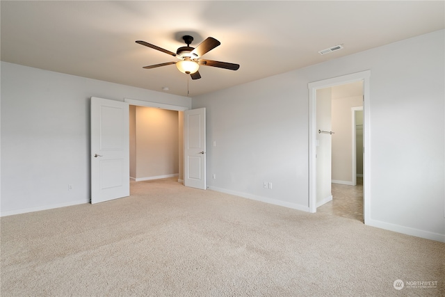 unfurnished bedroom with ceiling fan and light carpet