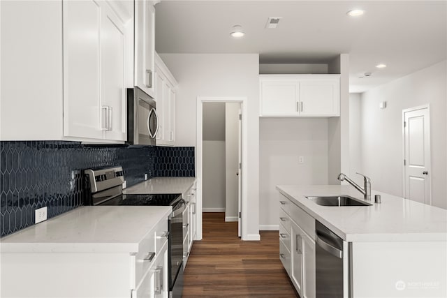 kitchen featuring white cabinets, a center island with sink, sink, appliances with stainless steel finishes, and dark hardwood / wood-style flooring