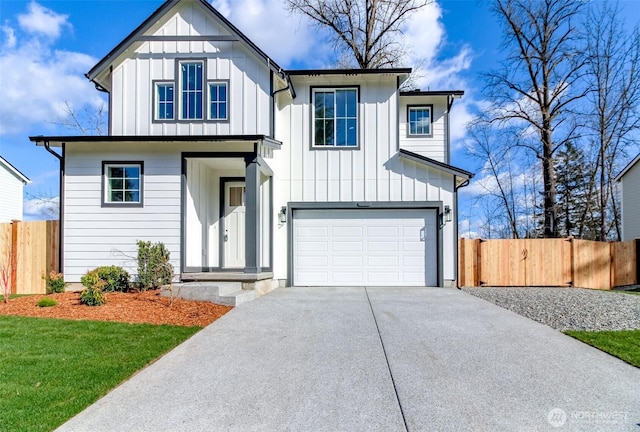 modern farmhouse with board and batten siding, concrete driveway, an attached garage, and fence