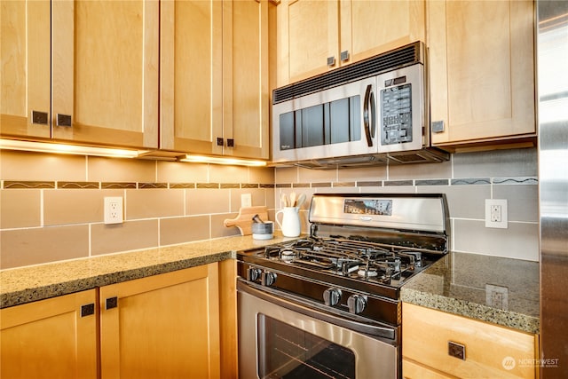 kitchen featuring light stone countertops, light brown cabinets, backsplash, and stainless steel appliances