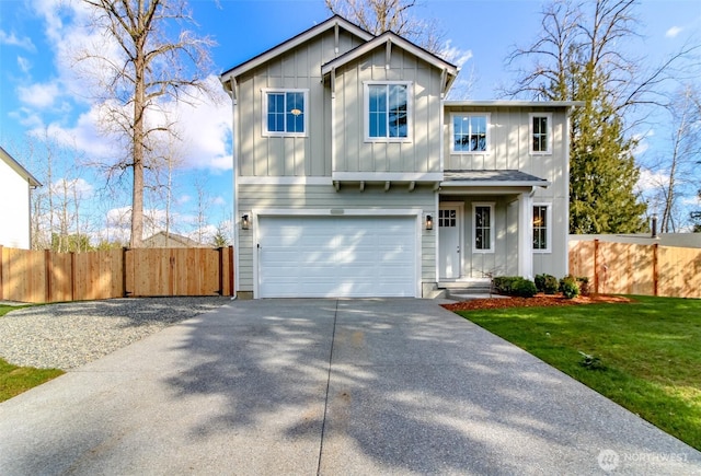 view of front of house with board and batten siding, fence, a front yard, driveway, and an attached garage