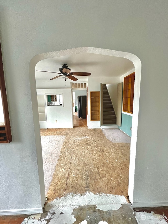 unfurnished living room featuring ceiling fan