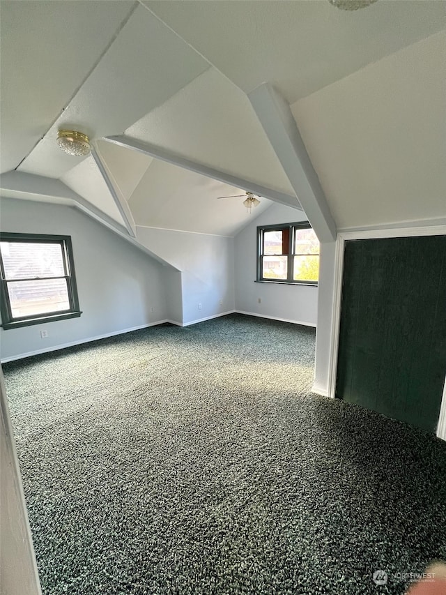 additional living space with vaulted ceiling and carpet