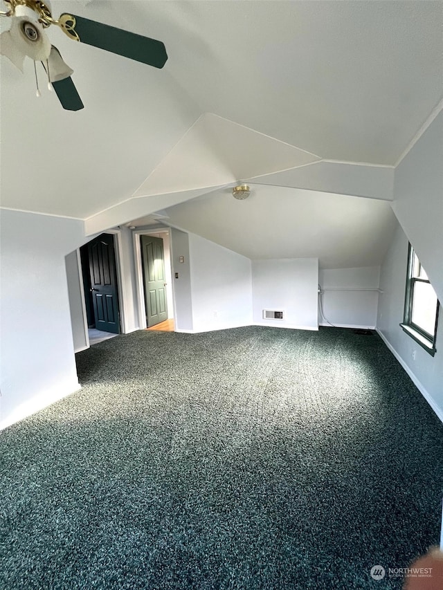 additional living space featuring ceiling fan, lofted ceiling, and carpet floors