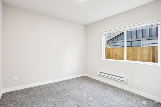 empty room with carpet floors and a baseboard heating unit