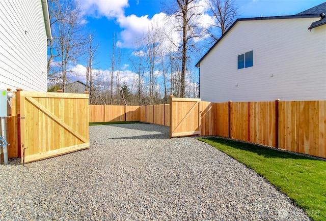 view of yard with fence and a gate