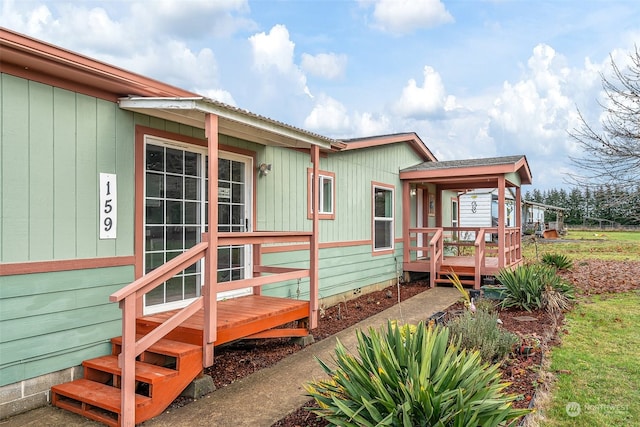 back of property featuring a wooden deck