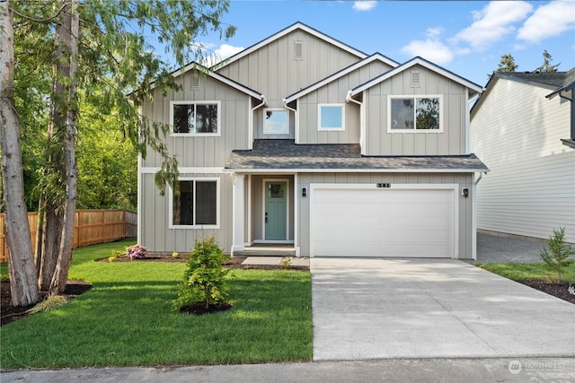 view of front of house with a front yard and a garage