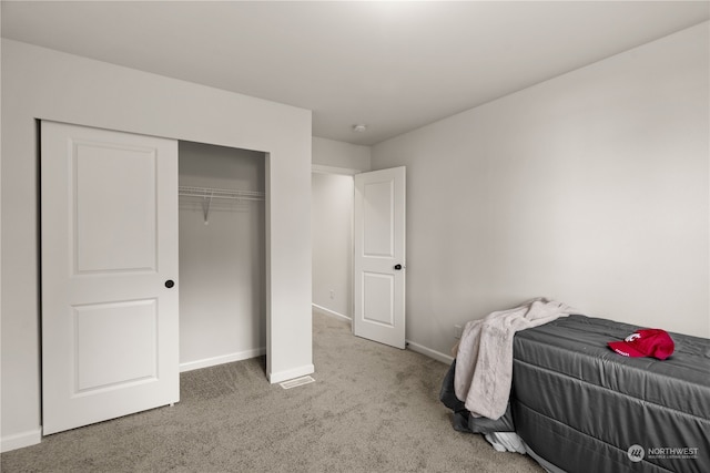 carpeted bedroom featuring a closet