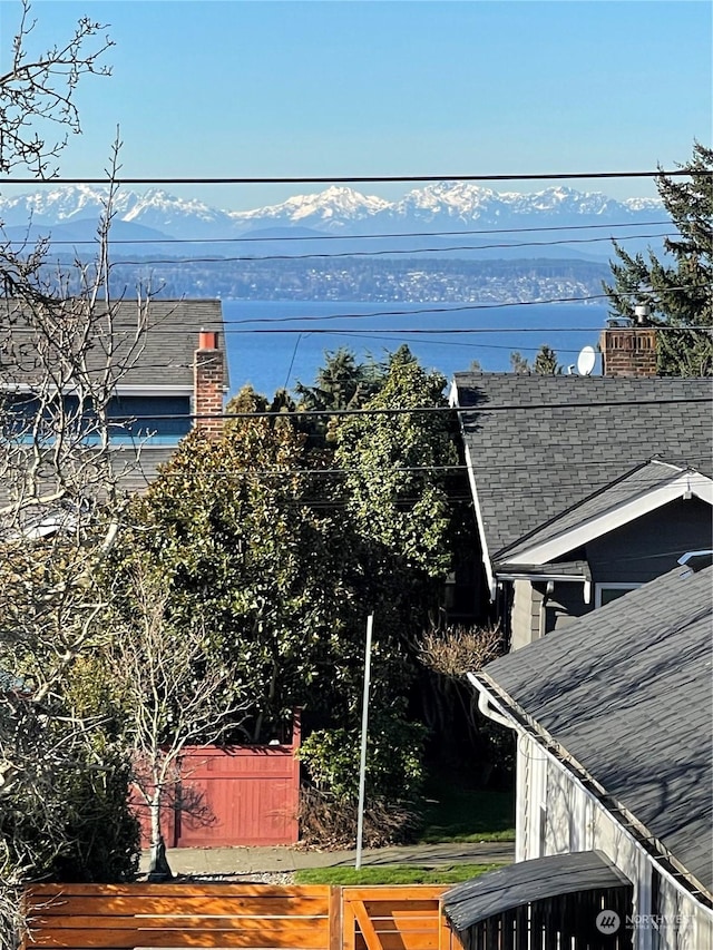 view of water feature featuring a mountain view and fence