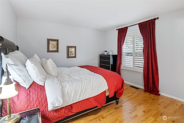 bedroom with hardwood / wood-style flooring