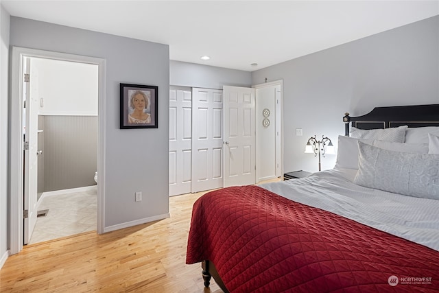 bedroom with light hardwood / wood-style flooring and a closet