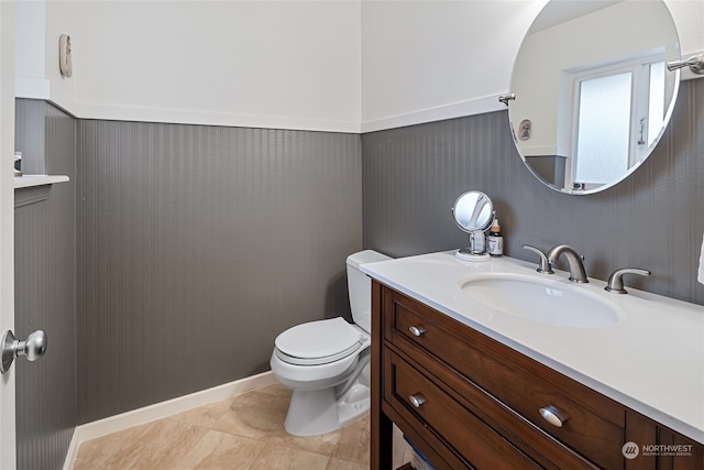 bathroom featuring toilet, vanity, and tile patterned floors