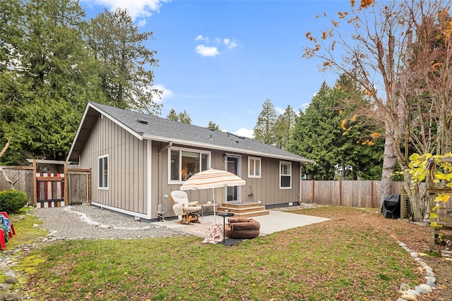 back of property featuring a patio area and a lawn