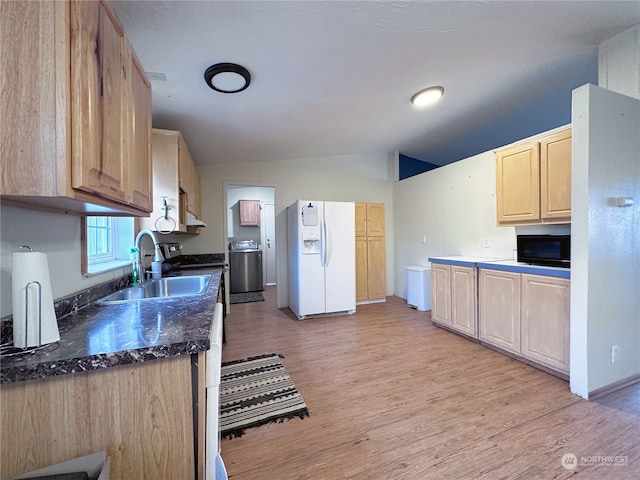 kitchen featuring sink, white fridge with ice dispenser, lofted ceiling, and light hardwood / wood-style flooring