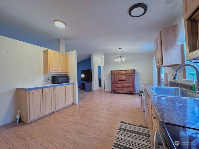 kitchen with light brown cabinetry, light wood-type flooring, stainless steel range, sink, and a notable chandelier