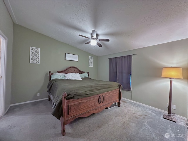 carpeted bedroom featuring ceiling fan, a textured ceiling, and vaulted ceiling