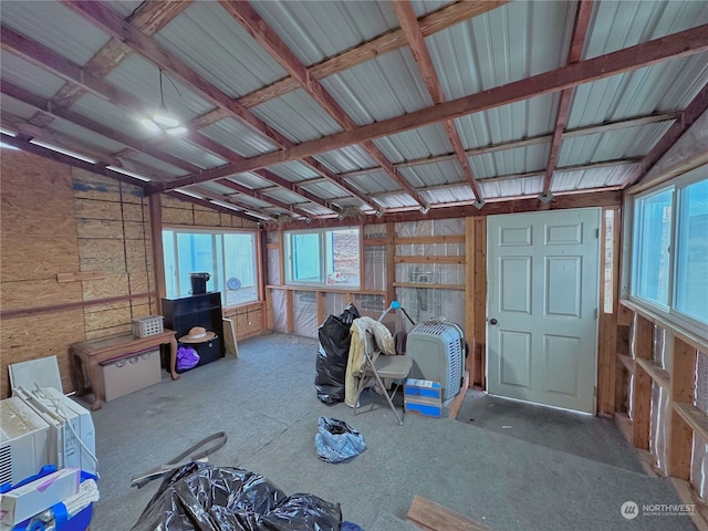 miscellaneous room with vaulted ceiling with beams