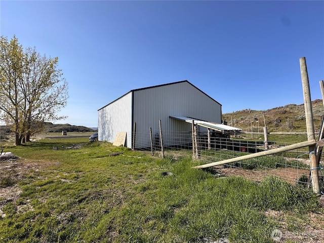 view of pole building featuring fence