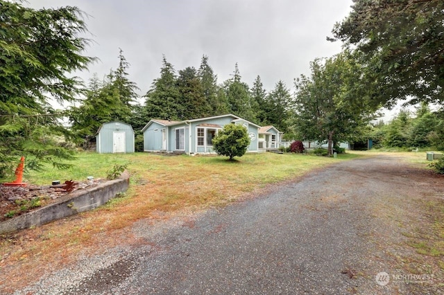 ranch-style house featuring a shed