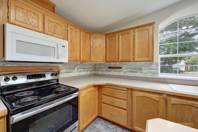 kitchen with tasteful backsplash, lofted ceiling, and stainless steel electric range