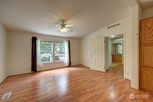 unfurnished room with ceiling fan, light hardwood / wood-style floors, and vaulted ceiling