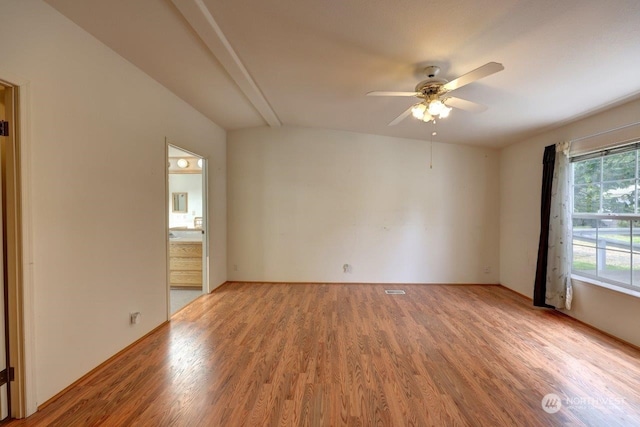 empty room featuring plenty of natural light, ceiling fan, and light wood-type flooring