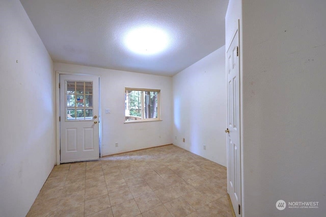 spare room featuring a textured ceiling