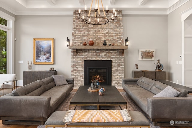 living room with coffered ceiling, ornamental molding, a fireplace, and beam ceiling