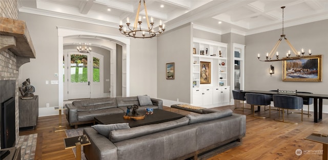 living room with coffered ceiling, a chandelier, hardwood / wood-style floors, and beam ceiling