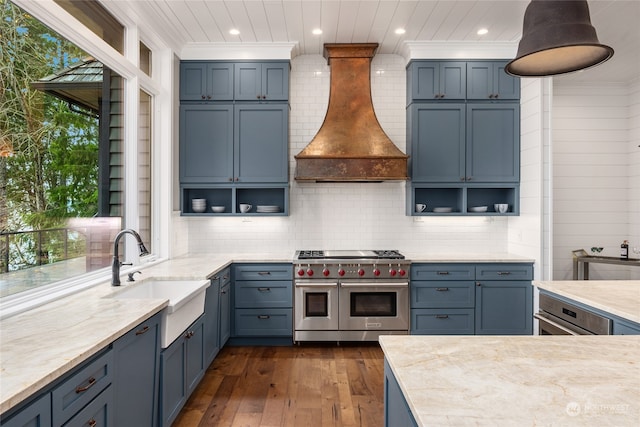 kitchen with pendant lighting, sink, custom exhaust hood, ornamental molding, and stainless steel appliances