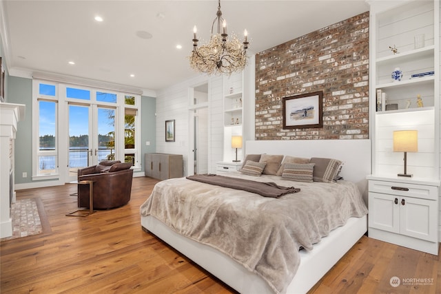 bedroom featuring access to outside, ornamental molding, and light hardwood / wood-style floors