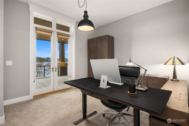 carpeted home office featuring french doors