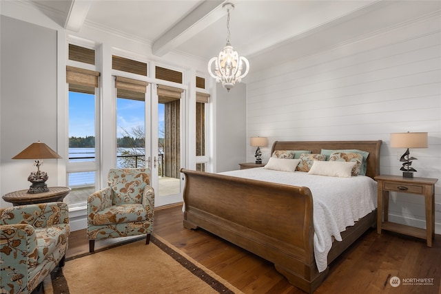 bedroom with dark hardwood / wood-style floors, a chandelier, access to exterior, a water view, and beam ceiling