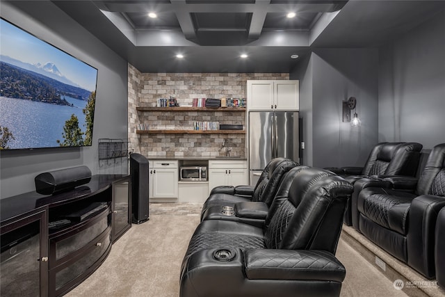 carpeted cinema featuring coffered ceiling, sink, and beam ceiling