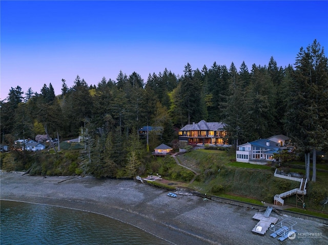 aerial view at dusk featuring a water view