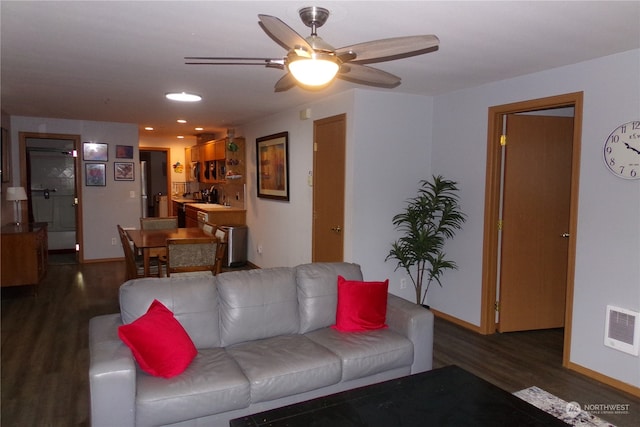 living room featuring ceiling fan, dark hardwood / wood-style flooring, and sink