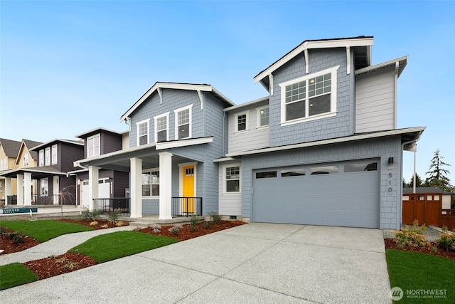 view of front of home with concrete driveway, a garage, and covered porch