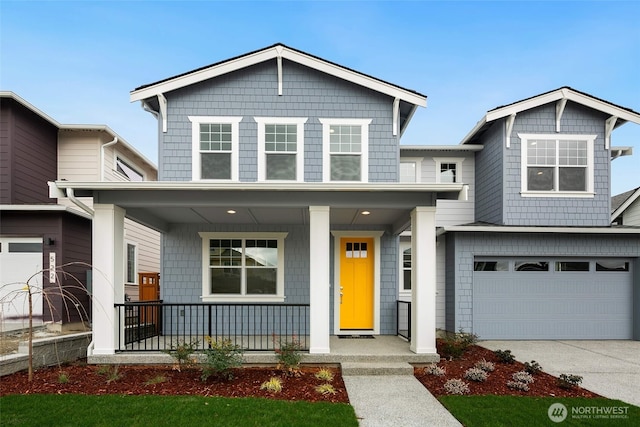 view of front of property featuring covered porch, an attached garage, and concrete driveway